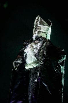 a man dressed up as the wizard with white hair and beard wearing a black cape