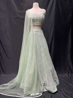 Look your best during festivals and special occasions with our Party Wear Lehenga D-157. Made from the highest quality materials for maximum comfort and durability, this beautiful lehenga will make you stand out in any crowd. Show your style: get Party Wear Lehenga D-157 today. Pista Color Lehenga Combination, Pista Green Lehenga With Cutdana For Designer Wear, Pista Green Lehenga With Cutdana Detail, Designer Pista Green Lehenga With Cutdana, Pista Green Floor-length Lehenga With Sheer Dupatta, Floor-length Pista Green Lehenga With Sheer Dupatta, Pista Green Fitted Sharara With Cutdana, Fitted Pista Green Sharara With Cutdana, Elegant Pista Green Lehenga With Cutdana