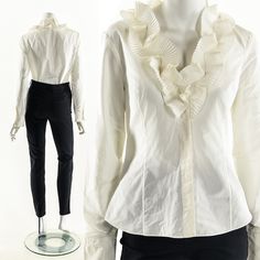 "-Vintage 90's pearly white origami blouse -Unique and interesting pleated crinkle ruffles placed around v neckline -Button down front hidden by front placket -Long sleeves -Princess seams for a tailored feminine fit Fits like: Small-Medium(Depending on Desired Fit) Material: Polyester Silk Blend Condition: Excellent Clipped on Mannequin: No ✂ S I Z E + F I T ✂ Length: 24\" / 61 cm Shoulders, seam to seam: 15.5\" / 39 cm Sleeve: 24.5\" / 62 cm Bust: 40\" / 102 cm Waist: 34\" / 86 cm All measurem Elegant Workwear Shirt With Ruffled Collar, Fitted Ruffle Shirt Elegant Style, Elegant Ruffled Shirt For Spring, Spring Formal Shirt With Ruffled Collar, Formal Ruffled Button-up Top, Elegant Ruffled Button-up Shirt, Formal Ruffled Collared Shirt, Spring Formal Blouse With Ruffled Collar, Formal Shirt With Ruffled Collar For Spring