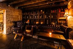 a living room filled with furniture and a fire place in front of a bookshelf