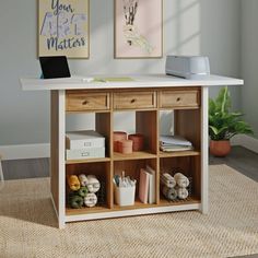 a computer desk with two drawers and an open laptop sitting on it's side