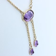 "Vintage Minimalist Lavalier Necklace in 14k Gold with Bezel Set, Oval Cut, Amethysts. This necklace bears a makers hallmark with \"rings and the letter A\", there is also a 14k Purity mark, no origin mark. Necklace measures 15.75\" Total Drop of Lavalier Pendant 1.75\" 1X - 13.6x9.8x5.85 mm Large Amethyst Oval Gem 2X - 7x4.5x3.75 mm Small Amethyst Oval Gems Total weight of necklace 0.179 Oz (78.1 g) This item is vintage. It has been cherished, worn, and preserved by possibly many over the decad Dainty Briolette Necklace For Formal Occasions, Formal Briolette Necklace With Polished Finish, Formal Briolette Necklace With Bezel Setting, Elegant Yellow Gold Lariat Necklace With Gemstone, Formal Drop Necklace With Bezel Setting, Formal Drop Necklaces With Bezel Setting, Elegant Oval Lariat Necklace As Gift, Elegant Oval Lariat Necklace For Gift, Formal Yellow Gold Briolette Necklace