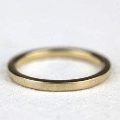 "Simple rose gold flat wedding band. This solid 14k rose gold women's wedding ring is the perfect little band to wear everyday. I created this ring from solid 14k rose gold. 14k yellow and white gold are also options. The band can be finished with a matte/brush finish (as shown on the rose gold rings) and polished (as shown on the yellow gold rings). Please leave the finish you would like in the \"notes\" box at checkout. If you do not specify it will be polished. The ring measures 1.5mm x 1.5mm Minimalist Wedding Bands With Smooth Finish, Minimalist Anniversary Bands With Smooth Finish, Simple 14k Rose Gold Stackable Rings, Minimalist Stackable Rose Gold Bands, Minimalist Rose Gold Bands For Everyday, Minimalist Stackable Wedding Rings With Smooth Bezel, Minimalist Wedding Band With Polished Edges, Minimalist Yellow Gold Thick Band Wedding Ring, Gold Stackable Rings In 14k Rose Gold