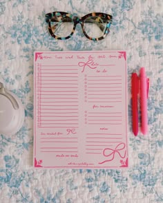 a pink to do list with glasses on it next to a pair of eyeglasses