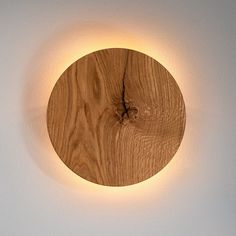 a circular wooden light mounted on the wall