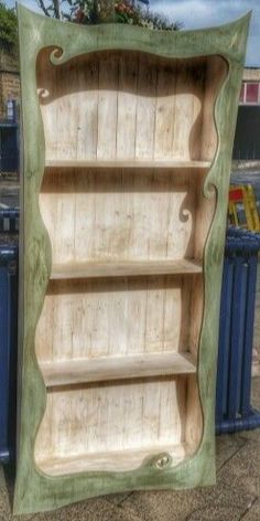 an old bookcase is painted green and blue