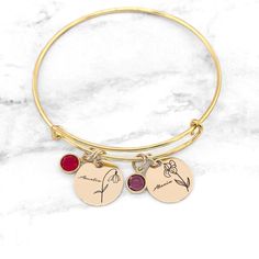 "Birth Flower Bracelet * Birthstone Bracelet * Birth Month Flower Bracelet * Personalized Birth Flower Bracelet * Gift For Mom Have this bangle bracelet personalized with the birth flower(s) and birthstone(s) of your choice! Personalized jewelry makes the perfect gift for so many occasions. Each charm measures 5/8\" which makes this bracelet dainty and simple, yet full of personal meaning! It is also adorned with a beautiful birthstone. » The bracelets are made with sterling silver, gold-filled Birth Flower Bracelet, Handwriting Bracelet, Sister Jewelry, Sister Necklace, Birth Month Flower, Birthstone Bracelet, Bracelet Dainty, Month Flowers, Birth Month Flowers