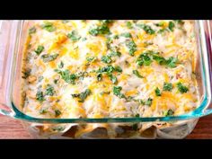 mexican enchiladas in a glass casserole dish on a wooden table