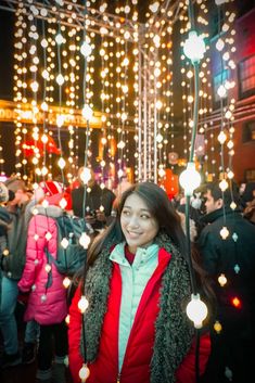 a woman is standing in front of some lights