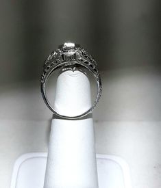 A wonderful Victorian band with great filigree detail. The center stone measures out at .80 ct and has a clarity of SI1 and G color. There is a small natural crystal on the girdle. On either side are 2 @.05ct diamonds set in diamond shape gold. The band weighs 2.5 grams and is is excellent condition. It measures 8.5mm across the top. Oval Diamond Ring For Wedding And Anniversary, Platinum Asscher Cut Wedding Ring In Diamond White, Antique Brilliant Cut Diamond White Ring, Antique Brilliant Cut Diamond White Diamond Ring, Antique Diamond White Diamond Ring With Brilliant Cut, Antique Diamond Rings With Vvs Clarity, Classic Formal Jewelry With Diamond Accents, Classic Oval Engraved Ring With Brilliant Cut, Diamond Ring With Accents For Marriage