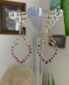 These amethyst earrings are shaped with loops and chains to create a flowing shape and light catching angles. Purple Amethyst Drop Teardrop Earrings, Purple Amethyst Teardrop Earrings, Purple Dangle Chandelier Earrings, Purple Amethyst Jewelry With Dangling Beads, Purple Dangle Teardrop Earrings With Ear Wire, Purple Nickel-free Teardrop Dangle Earrings, Purple Long Drop Jewelry With Ear Wire, Teardrop Amethyst Chandelier Earrings For Jewelry Making, Purple Wire Wrapped Long Drop Jewelry