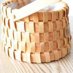 a wooden basket sitting on top of a table