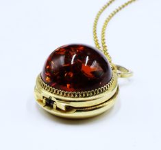 Vintage European gold tone & dome faux amber locket watch pendant necklace 199 Vintage European gold tone and dome faux amber locket watch pendant necklace, In good worked condition, The chain 17" long, Watch pendant  25 mm across 15 mm thick. Amber 20 mm across. Thanks, Gold Necklaces With Detachable Pendant For Collectors, Collectible Gold Jewelry With Detachable Pendant, Gold-tone Locket Jewelry For Formal Occasions, Antique Gold Jewelry With Detachable Pendant, Gold Domed Jewelry Gift, Amber Locket Jewelry For Gift, Amber Locket Jewelry As A Gift, Round Locket Necklace With Detachable Pendant As Gift, Vintage Domed Jewelry Gift