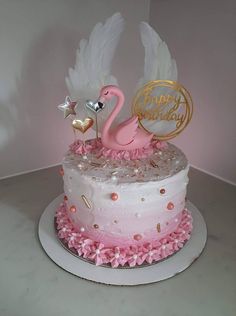 a pink and white cake with a flamingo on top