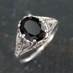 Onyx Ring Silver Filigree Ring 8 by 10 Oval Onyx Ring Dark Fairy Antique Style Ring Facetted Genuine Onyx Oval Ring Unique Engagement Ring This large onyx steals the show! This genuine facetted oval Onyx measures 8mm by 10mm. it is expertly set in an intricate filigree six prong mounting. The solid sterling silver mounting features plenty of delicate details that have the look of fine lace--complimenting the stunning stone. Your ring will be made to size just for you and given a meticulously hig Black Oval Filigree Ring For Formal Occasions, Gothic Oval Rings For Formal Occasions, Gothic Oval Wedding Ring, Heirloom Black Oval Ring, Gothic Gemstone Rings With Oval Shape, Onyx Antique Ring, Vintage Black Oval Filigree Ring, Gothic Oval Gemstone Rings, Black Oval Filigree Ring