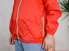 "UNCLE ED PRESENTS - vintage 90's red windbreaker/raincoat - the hood hidden in the collar - 2 outside pockets - materials: 100% nylon CONDITION (1-10 ❶❷❸❹❺❻❼❽ Good condition. The jacket is washed and ready to wear. SIZE/MEASUREMENTS size from label: 52/54 best fits men: L/XL chest: 50,5 inches (128 cm) length: 29 inches (74 cm) sleeve length from armpit: 21,5 inches (55 cm) The model is 6'3\" (190 cm), measures 45-36-43,5 (114-92-110 cm) and wears size L and XL WE SHIP WORLDWIDE FOLLOW US: inst Red Windbreaker For Spring Outdoor Activities, Red Windbreaker For Outdoor Activities In Spring, Red Spring Windbreaker For Outdoor Activities, Red Windbreaker For Spring Outdoors, Red Spring Windbreaker For Outdoor, Red Nylon Windbreaker For Spring, Red Windbreaker With Pockets For Streetwear, Red Nylon Windbreaker For Streetwear, Red Hooded Nylon Windbreaker