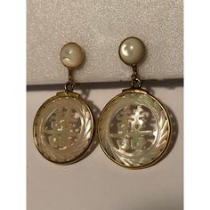 This is a lovely pair Vintage Japanese Mother of Pearl Dangle Earrings that will look amazing day and night. The round abalone post part of the earrings is surrounded by a gold-filled, beaded outer-ring as is the handcarved, dangle part of the earrings that has Japanese wording carved out. These screw back Asian-inspired earrings are really quite feminine, reflect the light beautifully and will be a nice addition to your vintage jewelry collection.  Condition: Excellent vintage condition; please see pics for details. Marks: none Dimensions: approximately 1"W x 1.75"L Elegant Pierced Jewelry In Mother Of Pearl, Elegant Mother Of Pearl Jewelry, Gold Mother Of Pearl Earrings For Wedding, Gold Round Earrings With Mother Of Pearl, Vintage Round Pearl Drop Jewelry, Mother Of Pearl Drop Earrings For Anniversary, Mother Of Pearl Jewelry For Pierced Ears For Weddings, Formal Mother Of Pearl Round Earrings, Anniversary Mother Of Pearl Drop Earrings