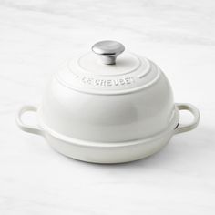 a white casserole sitting on top of a counter