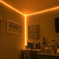 a room that has some lights on the ceiling and bookshelves in front of it