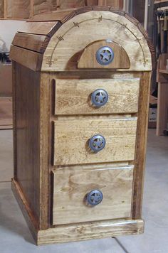 an old wooden box with three drawers on the bottom and two knobs at the top