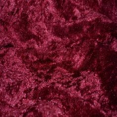 a close up view of a red velvet textured material with some small dots on it