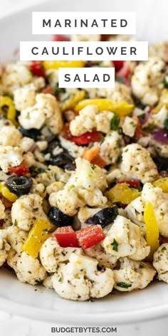 cauliflower salad in a white bowl with the words marinated cauliflower salad