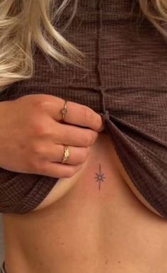 a close up of a person's stomach with a star tattoo on her left side