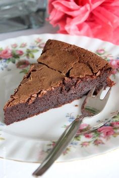 a piece of chocolate cake on a plate with a fork