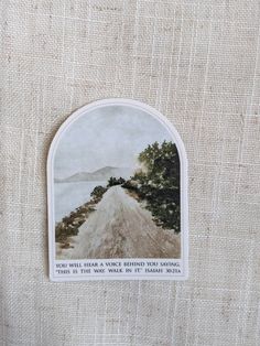 a sticker on the side of a piece of fabric with an image of a road