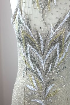 "There is actually a jacket that comes along with this..that is also quite stunning. Fabulous dress for a wedding. long high necked gown with beautifully beading silver, gold, ivory and silver..just outstanding. Excellent condition Dress: Measuring: 59\" long Bust: 36\"+ 38 Waist: 30\" Hip: 36\"+ 38\" (some stretch in the bust and hip) Jacket Measuring: 30\" length Width: 40\" Sleeves: 24\" There are shoulder pads in this Beautiful beaded jacket Pet Free/smoke free Enjoy!" Elegant Hand Embellished Silver Gown, Elegant Silver Hand-embellished Gown, Couture Sequined Evening Dress For Wedding, Sparkling Fitted Wedding Gown, Silver Fitted Hand Embellished Dresses, Glamorous Fitted Sequin Wedding Dress, Glamorous Fitted Wedding Dress With Sequins, Silver Fitted Wedding Dress For Evening, Elegant Silver Sequined Wedding Dress