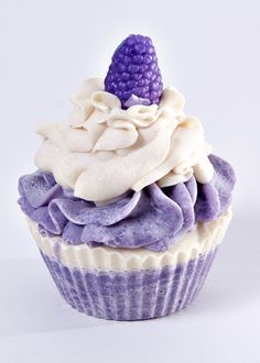 a purple cupcake with white frosting and a purple hat on top