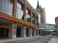 an empty street in front of a building with a sign on it that says greenwich corner