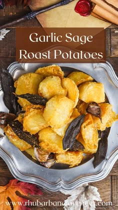 garlic sage roast potatoes in a silver bowl on top of a wooden table with fall leaves