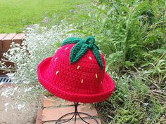 Gorgeous strawberry crochet bucket hat - the perfect summer festival wear.  Juicy strawberry red with green leaves and stem plus golden seeds. This hat is crocheted in chunky yarn so that it holds it's shape well, enabling you to adjust it to the look you want to achieve.  You can have the brim up or down, half up or half down - however you want to wear it in the coolest way for you. Beautifully finished - made from chunky acrylic yarn. Size fits teen to adult - approximately 22 inches/56cm. To Strawberry Bucket Hat, Fruit Hat, Strawberry Crochet, Novelty Hats, Crochet Bucket, Crochet Bucket Hat, Bucket Hats, Chunky Yarn, Summer Festival