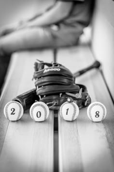 a baseball glove with numbers on it sitting in the dugout