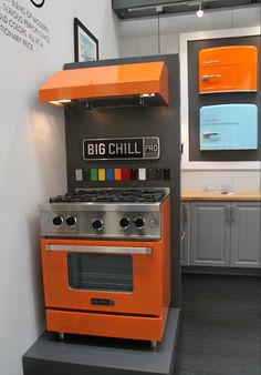 an orange stove top oven sitting inside of a kitchen