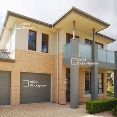 two story brick house with garage doors and windows