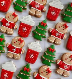 many decorated cookies in the shape of christmas trees and bears