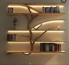 a book shelf with several books on it and some lights around the tree branch that is lit up