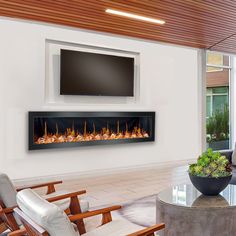 a modern living room with a large television mounted on the wall and a fire place