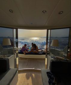 two people sitting on a boat in the ocean