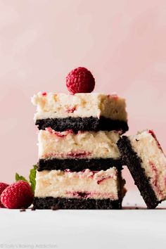 three pieces of cake with raspberries on top and one piece cut in half