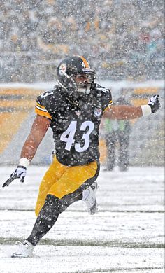 a football player is running in the snow