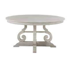 a white table with an ornate design on the top and bottom, against a white background