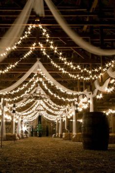 a barn with lights hanging from the ceiling