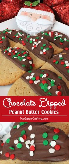 chocolate dipped peanut butter cookies on a plate with santa clause in the background and christmas decorations