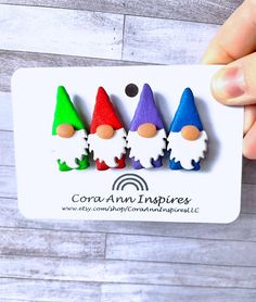 three little gnomes are sitting on top of each other in the shape of magnets