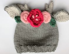 a knitted hat with flowers and leaves on it