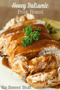 a plate topped with meat covered in gravy