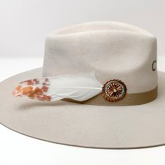 Oval Concho With white and orange Feathers Hat Pin With AB crystals. Pictured on a white background with the pin on the side of a light grey/ brown hat. Custom Cowboy Hats, Hat Bands, Beach Hats, Giddy Up Glamour, Head Pieces, Feather Hat, White And Orange, Hat Pin, Beach Hat